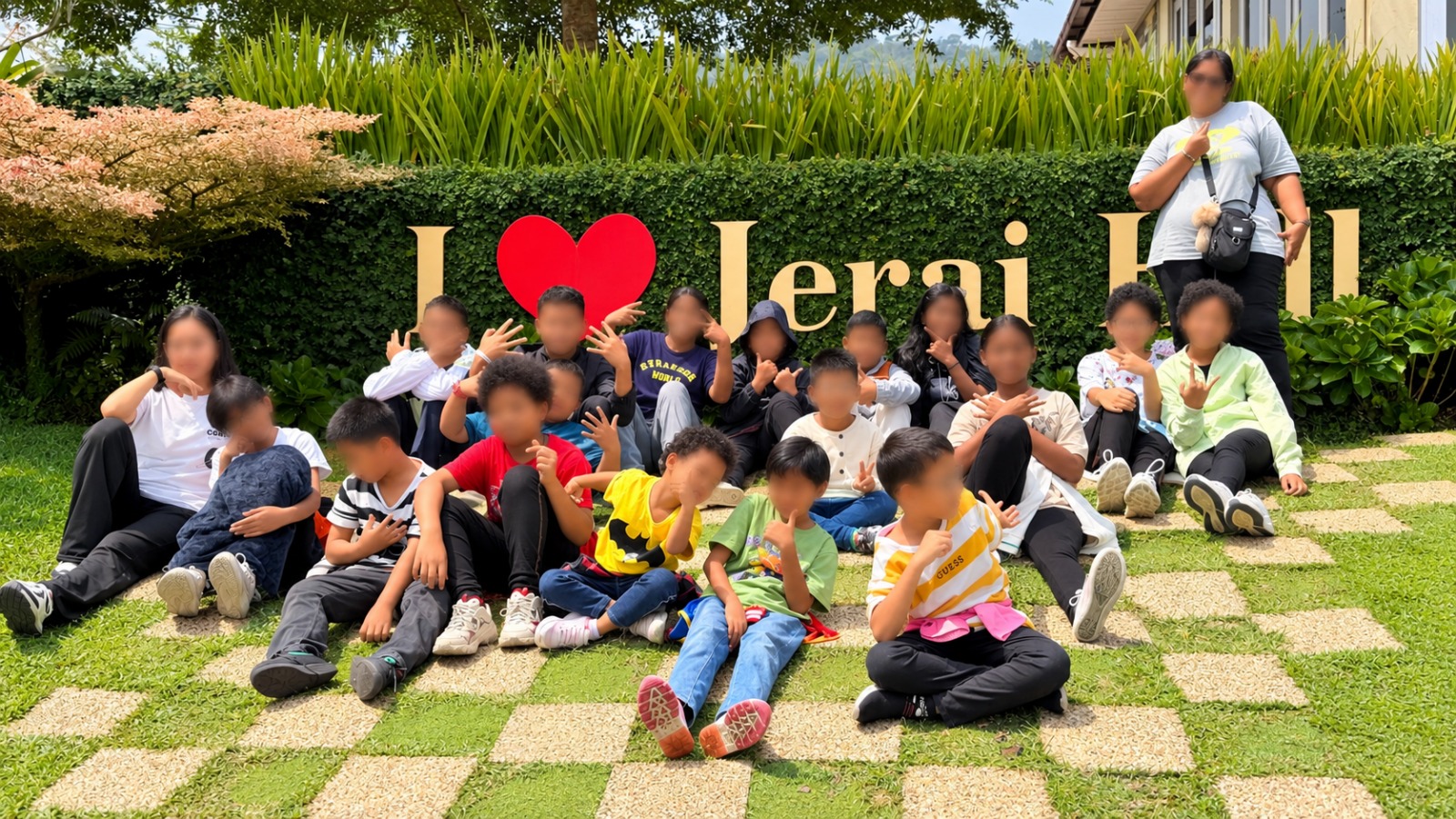 Children of St. Joseph's Home posing by the “I Love Jerai Hill” sign