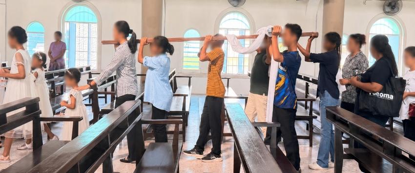 Older children of St Joseph's Home carrying the wooden cross in procession from St Francis Xavier Church